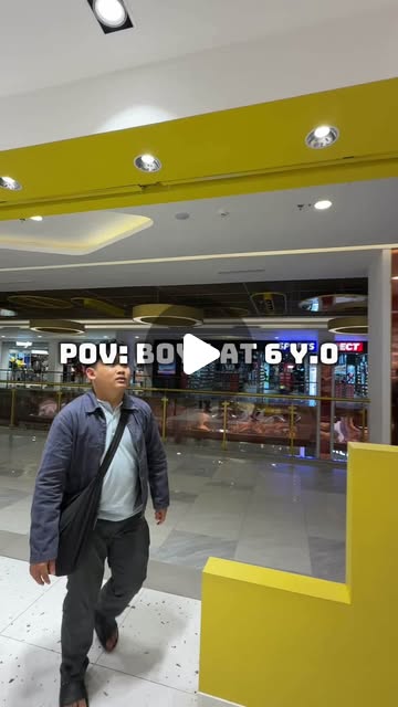 Adit walking toward the entrance of a LEGO store